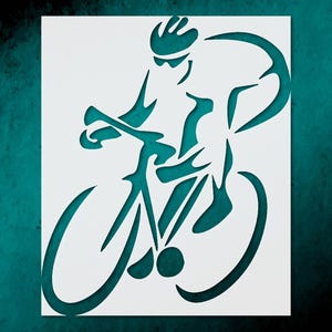 May include: A white stencil featuring a cyclist on a bicycle, with a teal background. The cyclist is wearing a helmet and sunglasses. The bicycle's wheels and frame are visible, creating a dynamic image.