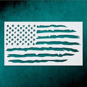 May include: A white stencil of the American flag with a distressed design. The stars and stripes are cut out, revealing the background. The flag is rectangular and set against a teal background.