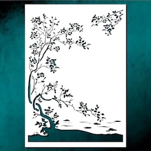 May include: A decorative paper cut-out featuring a stylized tree with branches, leaves, and flowers. The design is in dark teal against a white background, with a suggestion of a lake at the base. The artwork has a minimalist, nature-inspired theme.