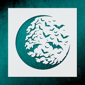 May include: A white stencil featuring a circular design of bats in flight. The bats are cut out of the white material, creating a negative space effect against a teal background. The design is suitable for Halloween crafts.
