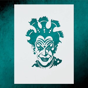 May include: A teal-colored stencil of a clown's face with a wide smile, elaborate makeup, and a detailed hairstyle. The clown has a beaded necklace and a star on each cheek. The image is on a white background.