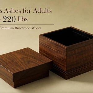 May include: A dark brown, rectangular wooden urn with a lid, made of premium rosewood. The open urn has a black interior. Text on the image reads: "Holds Ashes for Adults up to 220 lbs."