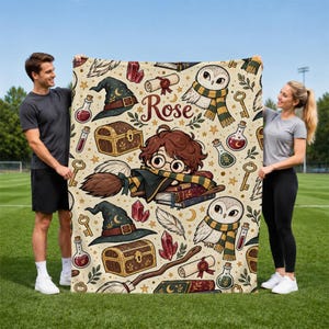 May include: A cream-colored fleece blanket featuring a repeating pattern of wizard-themed illustrations including owls, pointed hats, treasure chests, potion bottles, scrolls, and wands, with the name Rose printed in the center in red script.
