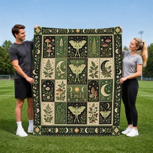 May include: A rectangular throw blanket featuring a dark green and cream botanical pattern with moths, crescent moons, ferns, mushrooms, and flowers. The center panel displays the name Emily in a decorative font surrounded by sun and moon motifs.