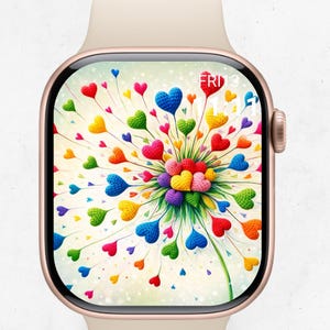 May include: A rose gold smartwatch with a cream-colored band displays a colorful heart-shaped dandelion design. The screen shows a variety of heart shapes in red, blue, green, yellow, and orange. The date, Friday the 3rd, is visible in the upper right corner.