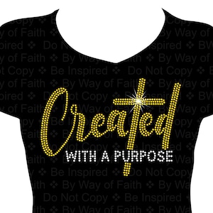 May include: Black t-shirt with gold glitter rhinestones spelling "Created with a Purpose" and a gold glitter cross.