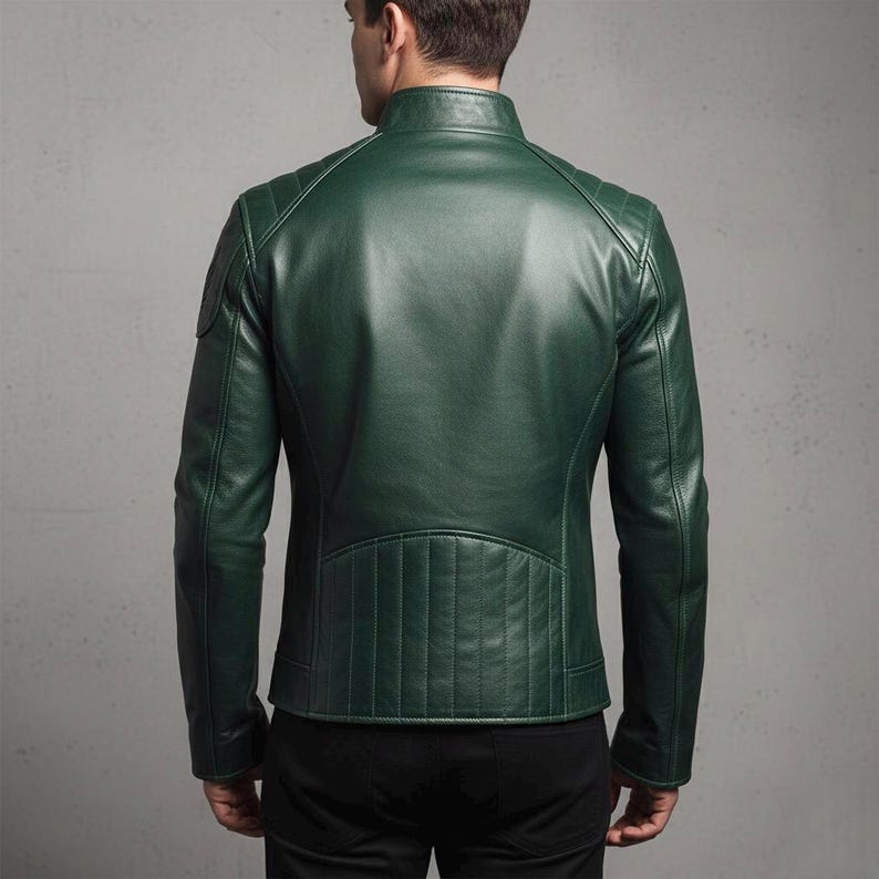 Deep green genuine leather biker jacket for men, featuring asymmetrical zip, stand-up collar with buckle, quilted shoulder panels, zippered cuffs, functional pockets, and embroidered wing patch – stylish and handcrafted motorcycle outerwear.