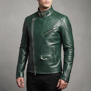 Deep green genuine leather biker jacket for men, featuring asymmetrical zip, stand-up collar with buckle, quilted shoulder panels, zippered cuffs, functional pockets, and embroidered wing patch – stylish and handcrafted motorcycle outerwear.