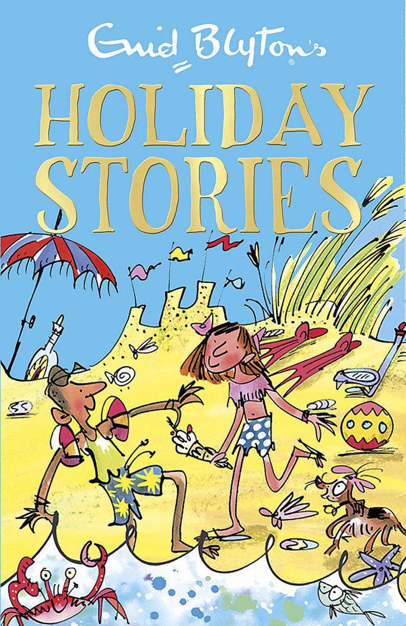 May include: A colorful illustration of a children's book cover titled "Enid Blyton's Holiday Stories." The image depicts a beach scene with cartoon figures, a beach umbrella, and various beach-related items. The background is a light blue sky.