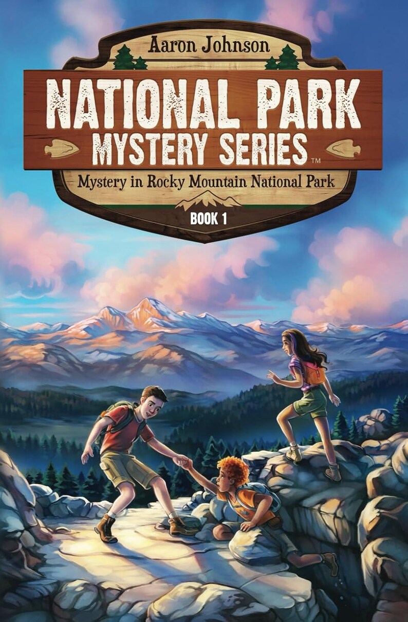 May include: A book cover illustration featuring three children hiking in a mountainous landscape. The cover features the title "National Park Mystery Series" and the subtitle "Mystery in Rocky Mountain National Park." The book is labeled "Book 1."