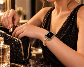 May include: A gold-toned smartwatch featuring a rectangular face with a black digital display and a decorative metal link band adorned with small, clear, star-shaped crystals. The watch is worn on the wrist, showcasing a polished metallic finish.