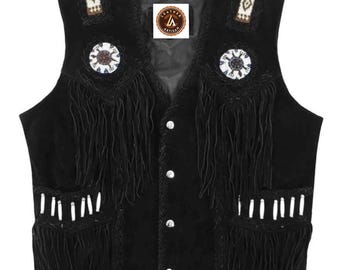 May include: Black suede vest with fringe, beaded shoulder accents, and decorative circular embellishments. Features a button-down front and pockets with white accents. A classic western-inspired garment.
