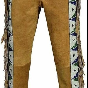 May include: Tan suede pants with decorative beaded trim in white, green, and blue along the sides. The pants have fringe along the sides and a patch of darker tan suede on the knees.