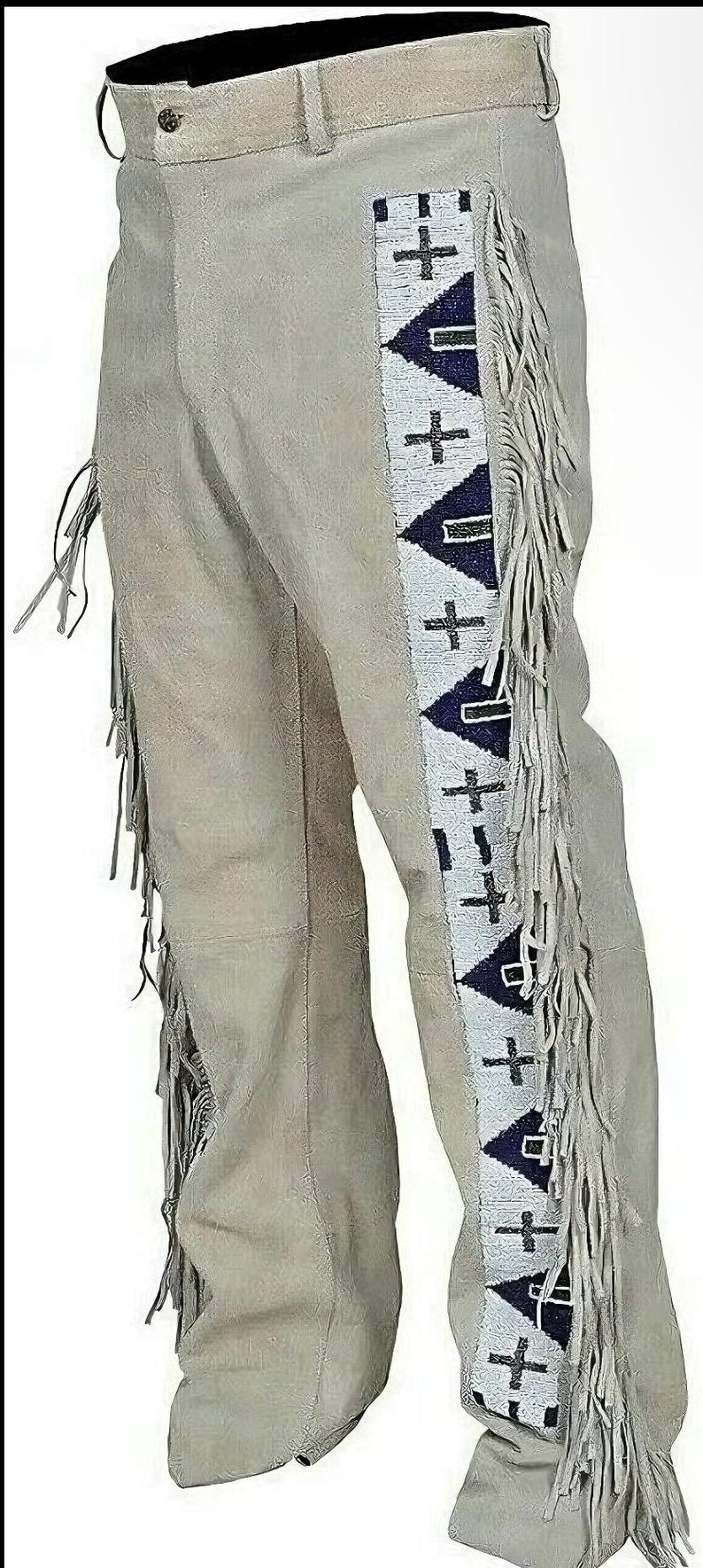 May include: Light gray suede pants with decorative fringe along the sides. The pants feature a beaded design with crosses and triangles in white, navy blue, and black. A traditional Western wear item.