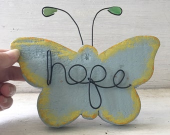 Wire word “hope” on wood butterfly and sea glass antenna wall art