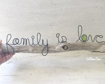 Wire words Family is Love with sea glass on driftwood