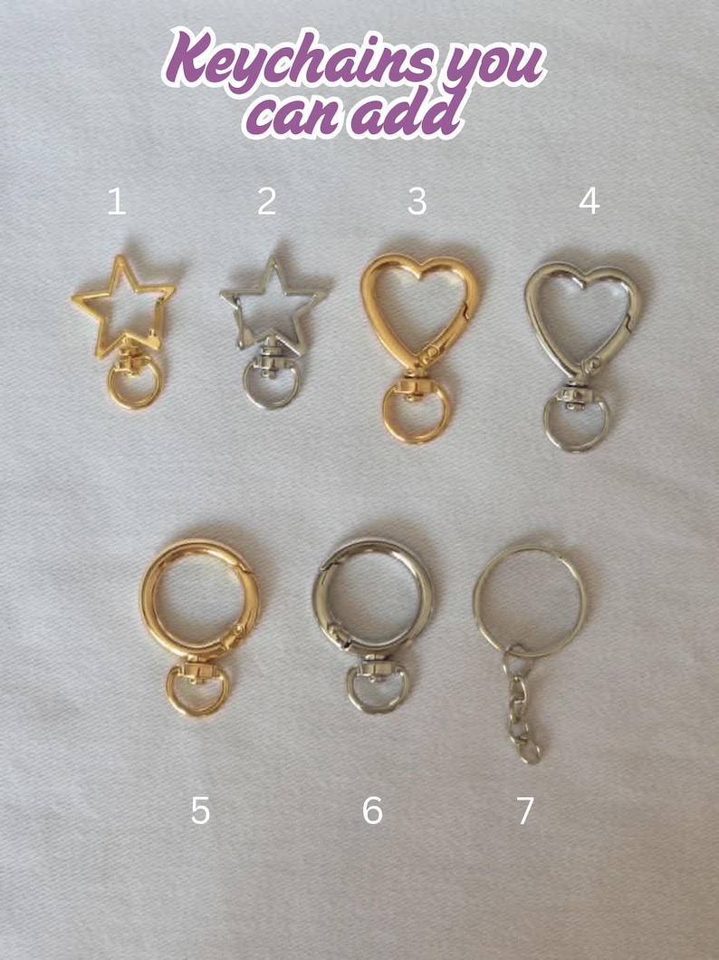 Op de afbeelding: Assortiment sleutelhangers in goud- en zilverkleuren, met ster- en hartvormen en ronde sluitingen. De afbeelding bevat de tekst "Keychains you can add."