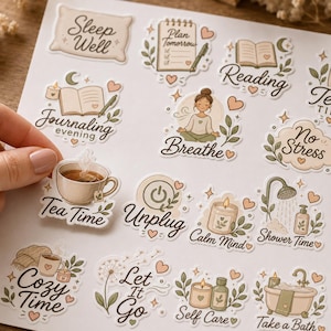 May include: A sheet of self-adhesive stickers featuring illustrations of wellness and relaxation themes. Designs include a pillow with Sleep Well, a planner, a book with Reading, a person meditating with Breathe, a tea cup with Tea Time, and a bathtub.