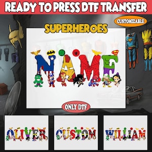 May include: A white DTF transfer featuring the word "NAME" in superhero-themed letters, with various superhero characters. The image includes the text "READY TO PRESS DTF TRANSFER", "SUPERHEROES", "CUSTOMIZABLE", and "ONLY DTF".