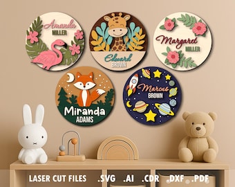 May include: A collection of five round wooden name signs with various designs. One features a flamingo, another a giraffe, and others a fox, flowers, and a space theme. Each sign includes a name and family name.