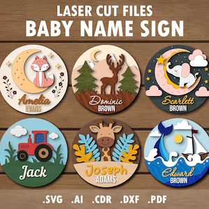 Puede incluir: Letreros de nombres de bebés de madera cortados con láser. Cada letrero presenta un tema diferente: un zorro en una luna, un ciervo en un bosque, un elefante en una luna creciente, un tractor, una jirafa y un velero. Los letreros incluyen nombres y el texto "BABY NAME SIGN".