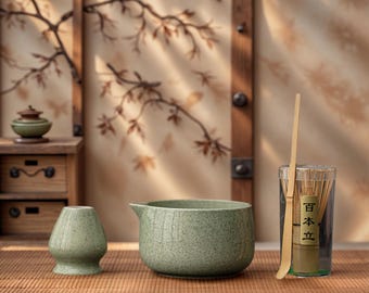 May include: A serene still life featuring matcha tea ceremony tools. Includes a green ceramic bowl, a small vase, a bamboo whisk, and a glass container with a bamboo whisk. The items are arranged on a bamboo mat.