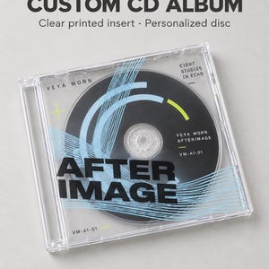 May include: A clear plastic CD jewel case containing a personalized disc. The cover features the text CUSTOM CD ALBUM, Clear printed insert, Personalized disc, VEYA MORN, EIGHT STUDIES IN ECHO, AFTER IMAGE, VEYA MORN AFTERIMAGE, and VM-AI-01.