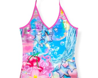 May include: A sleeveless halter top with a vibrant blue background featuring a graphic print of iridescent stars, pink cherries, bubbles, and a heart icon. The garment is finished with bright pink trim along the neckline and straps.