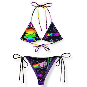 May include: A two-piece bikini set with a black background and colorful pixelated graphics. The top features a rainbow design and the text "POW XD". The bottom has a Nyan Cat graphic and a rainbow flag.
