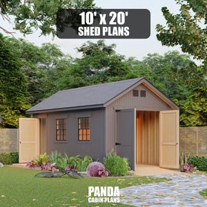 May include: A dark gray shed with light wood-toned double doors and two windows. The structure features a gabled roof and is labeled with the text 10' x 20' SHED PLANS and PANDA CABIN PLANS. The shed is situated in a grassy yard with trees.