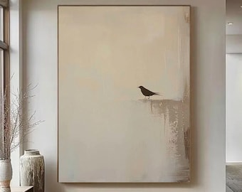 May include: Large abstract painting with a neutral color palette. The artwork features a black bird silhouette perched on a textured, light-colored surface. The painting is framed and displayed in a modern interior setting.
