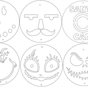 May include: Six white, circular cutouts with various face designs. One resembles a snowman, another a mustache, and a third has the text "SANTA CAM". The others feature stylized faces with unique expressions, perfect for holiday crafts.