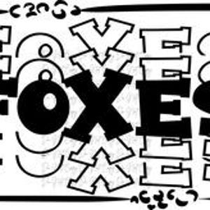 May include: Black and white graphic with the word "FOXES" in a bold, stylized font. The word is repeated in various sizes and orientations, with decorative elements like circles and leopard spots. The design is enclosed within a rectangular border.