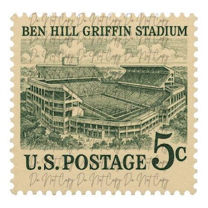May include: A vintage postage stamp featuring Ben Hill Griffin Stadium, rendered in green ink. The stamp reads "U.S. Postage" and "5c". The stadium is depicted with detailed architectural elements.