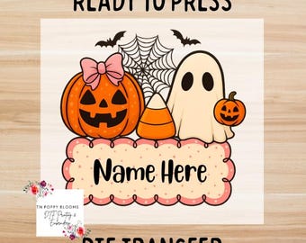 May include: A Halloween-themed DTF transfer design featuring a jack-o'-lantern with a pink bow, a ghost, candy corn, and a small pumpkin. The design includes the text "Name Here" and "Ready to Press" and "DTF Transfer".