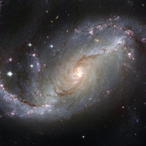 May include: A spiral galaxy with a bright, glowing center and swirling arms filled with stars and dust. The image showcases a cosmic structure with a mix of light and dark areas, and bright, distant stars.
