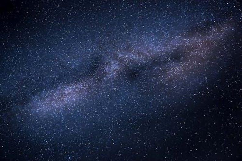 May include: A dark blue night sky filled with countless white and light blue stars. A bright, milky white and purple band of the Milky Way galaxy stretches across the image, creating a stunning celestial display.
