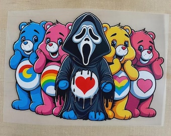 May include: A graphic transfer featuring four colorful cartoon bears and a central figure wearing a black hooded robe with a ghost mask. The bears have white belly patches with rainbow, heart, and sun symbols. The central figure has a red heart.