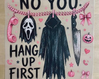 May include: A square print featuring the text NO YOU HANG UP FIRST in black letters. A pink telephone cord hangs across the top with a pink rotary phone, a white ghost mask, a black hooded robe, and a silver knife clipped to it with pink pins.