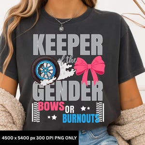 May include: Dark gray t-shirt with the text "KEEPER of the GENDER BOWS OR BURNOUTS". The design includes a car wheel, a pink bow, and stars. The shirt is made of a soft material.