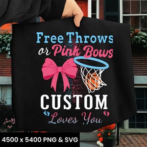 May include: Black tote bag with the text "Free Throws or Pink Bows" and "Custom Loves You". The design includes a pink bow, a basketball net, and a basketball. The bag is held by a person.
