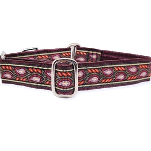 May include: A maroon dog collar with a paisley pattern in shades of red, pink, and gold.