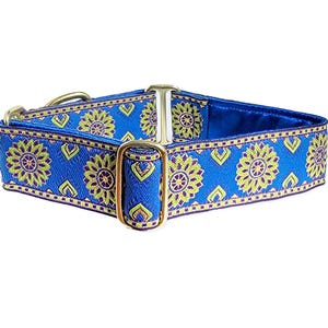 May include: A blue dog collar with a gold buckle and a floral pattern. The pattern features yellow and purple flowers on a blue background.