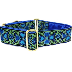 May include: A blue and green patterned dog collar with gold metal hardware. The collar has a geometric design with hearts and diamonds.