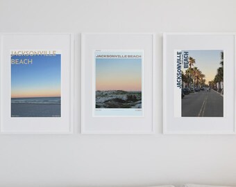 May include: Three framed art prints on a white wall. Each print features a photograph of Jacksonville Beach, Florida. The prints display a beach scene, ocean waves, and a street lined with palm trees. The text "JACKSONVILLE BEACH" is printed on each frame.