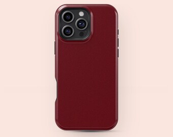 May include: A deep red phone case with a textured finish. The case has a rectangular form with rounded edges and a camera aperture. The case is designed for a smartphone and has a modern, stylish appearance.