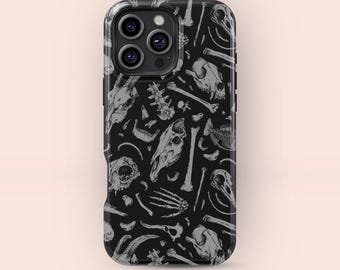 May include: Black phone case featuring a repeating pattern of gray animal skulls, bones, and skeletal elements. The case has a glossy finish and a camera module with three lenses. The design is a macabre, yet artistic, illustration.
