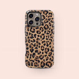 May include: A smartphone case with a leopard print design. The case has a pattern of brown and black spots on a tan background. The case has a glossy finish and a camera cutout.