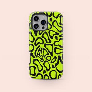 May include: A neon green phone case with a black abstract pattern. The case has a glossy finish and features a series of irregular, organic shapes in black against the bright green background. The phone's camera lenses are visible.