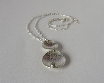 Silver two leaf dishes necklace with white topaz